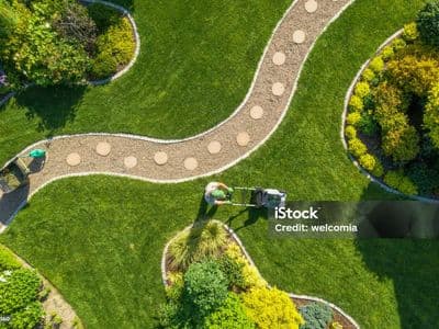overhead shot of man mowing lawn
